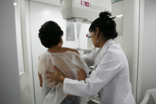 Photo of medical practitioner screening a patient of breast cancer